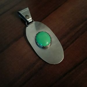 Green stone and silver tone pendant